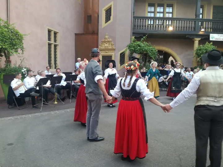 Folklore dancing in the evening at Colmar, Alsace (France)